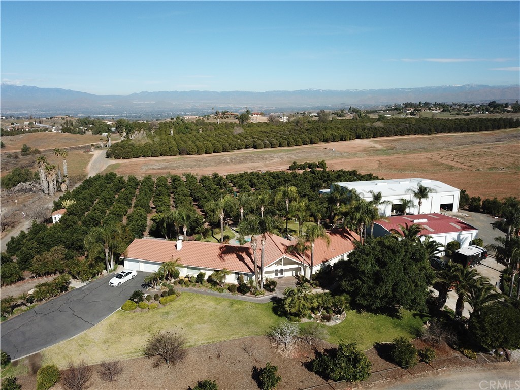 17850 Vista Del Lago Drive Riverside, CA 92503 - Photo 2 of 43 an aerial view of a house with a lake view