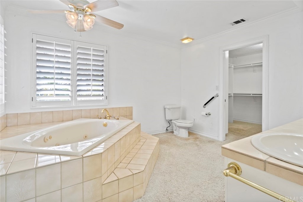 17850 Vista Del Lago Drive Riverside, CA 92503 - Photo 22 of 43 a bathroom with a tub a sink and a large mirror