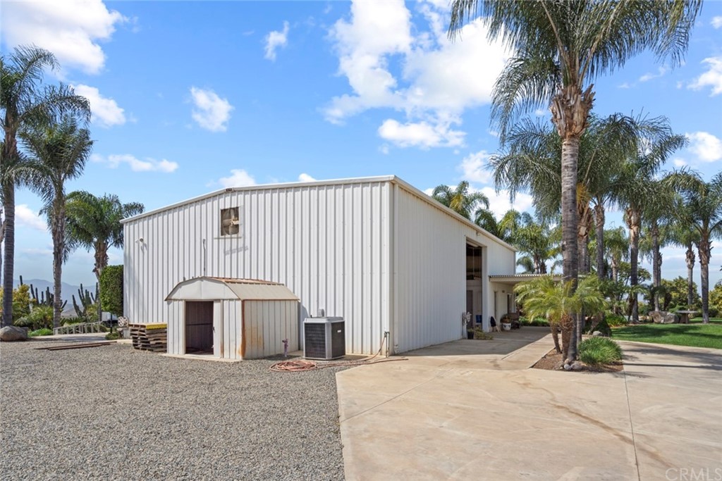 17850 Vista Del Lago Drive Riverside, CA 92503 - Photo 10 of 43 a view of a house with a yard and palm trees