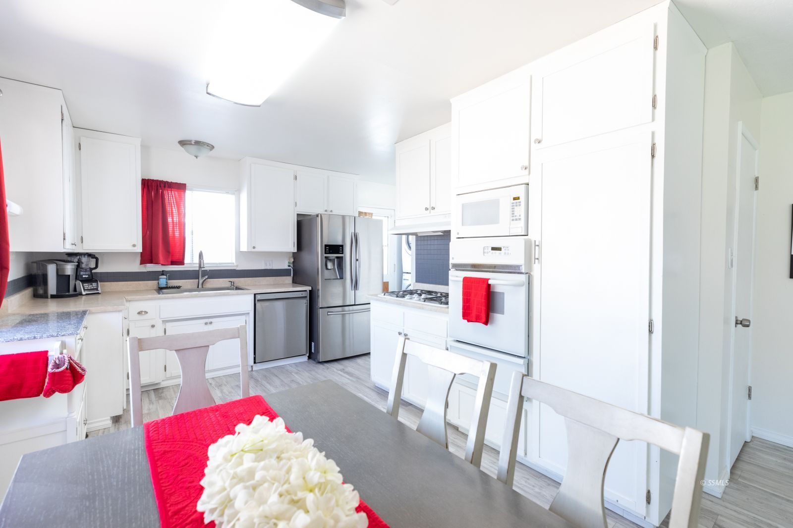 317 South Silver Ridge Street Ridgecrest, CA 93555 - Photo 12 of 28 a kitchen with white cabinets and white appliances