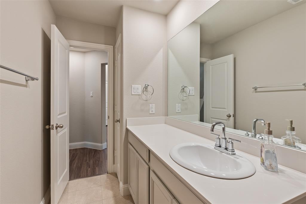 6909 Danridge Road Rowlett, TX 75089 - Photo 19 of 29 a bathroom with a sink and a mirror