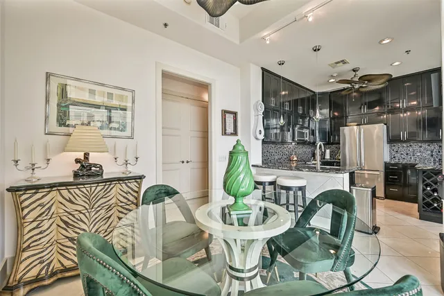 a dining room with furniture a wooden floor and a chandelier