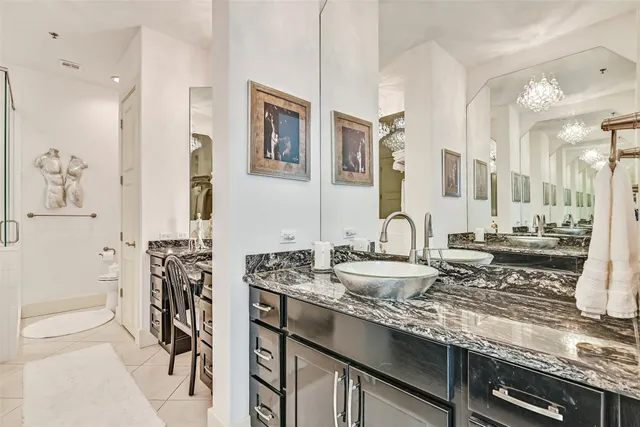 a bathroom with double vanity sinks a mirror and a shower