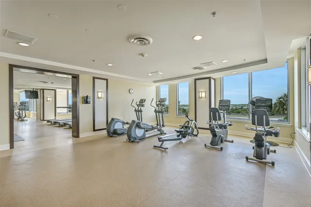 a view of a room with gym equipment and floor to ceiling window
