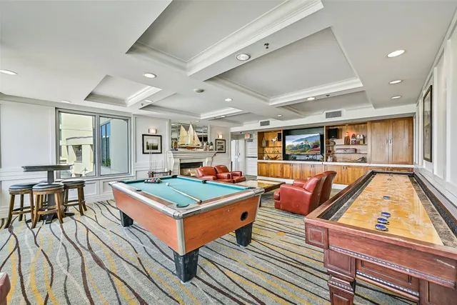 a living room with furniture a rug and a flat screen tv