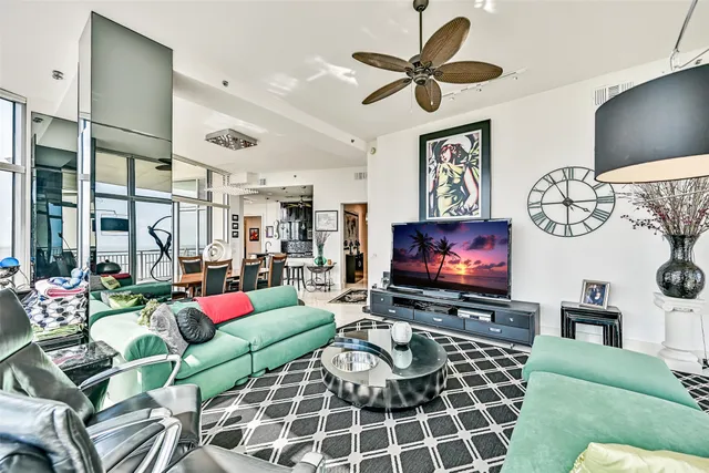 a living room with furniture a rug and a flat screen tv