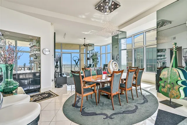 a dining room with furniture a rug and a large mirror