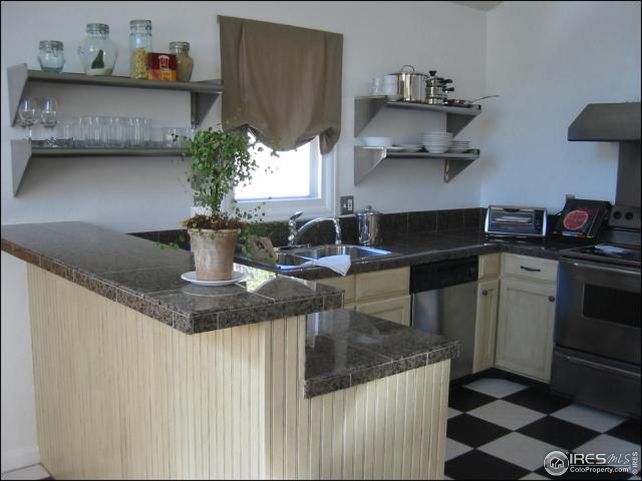 7140 Olde Stage Road Boulder, CO 80302 - Photo 3 of 12 a kitchen with stainless steel appliances granite countertop a sink and a stove