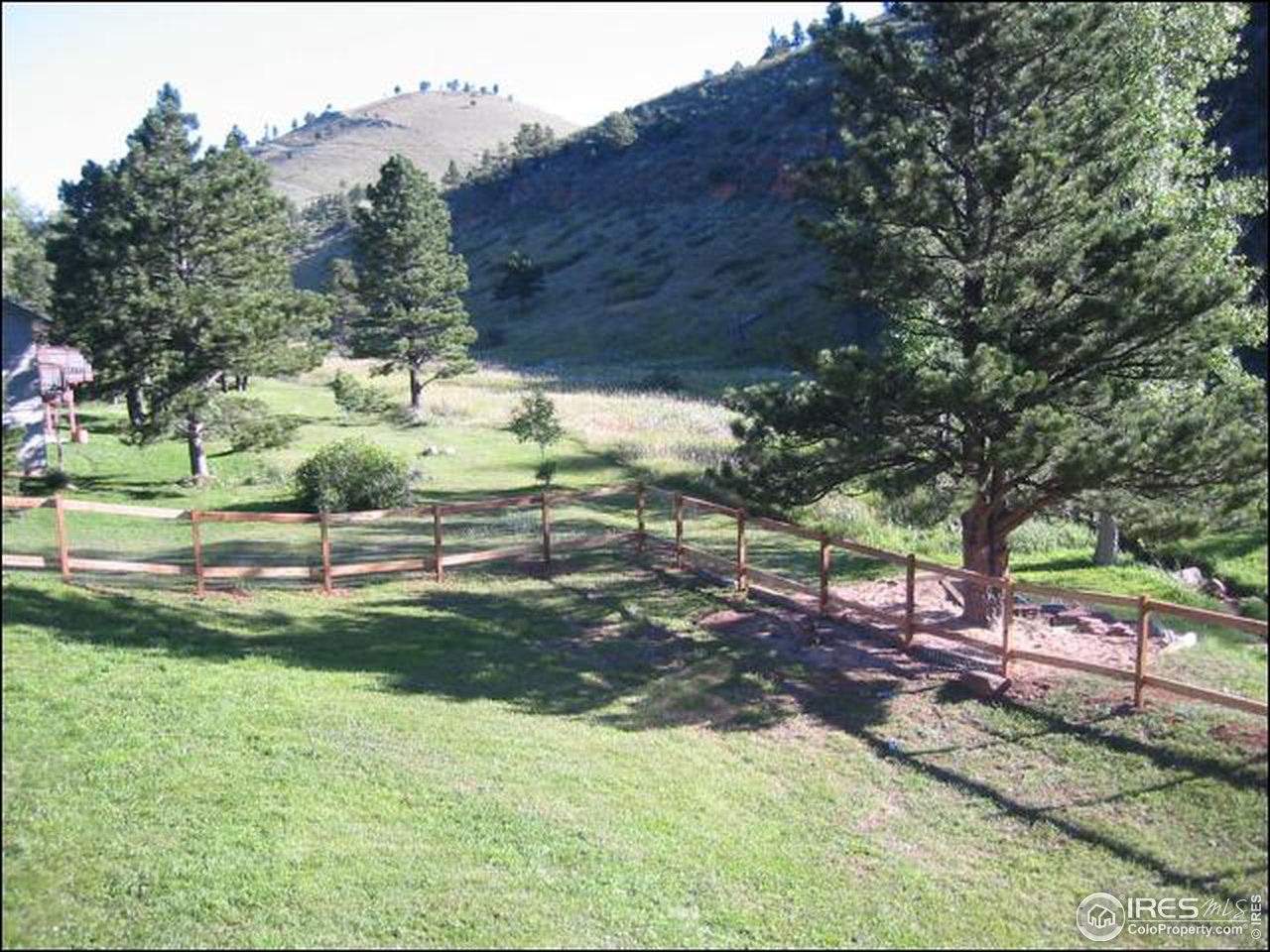 7140 Olde Stage Road Boulder, CO 80302 - Photo 10 of 12 a view of a backyard with table and chairs under an umbrella