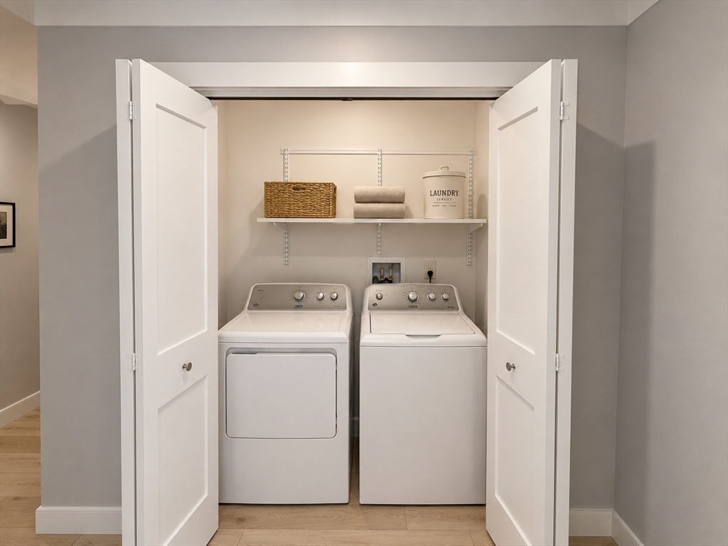 269 Main Street, Unit 2006 Reading, MA 01867 - Photo 6 of 10 a view of washer and dryer with kitchen in the background