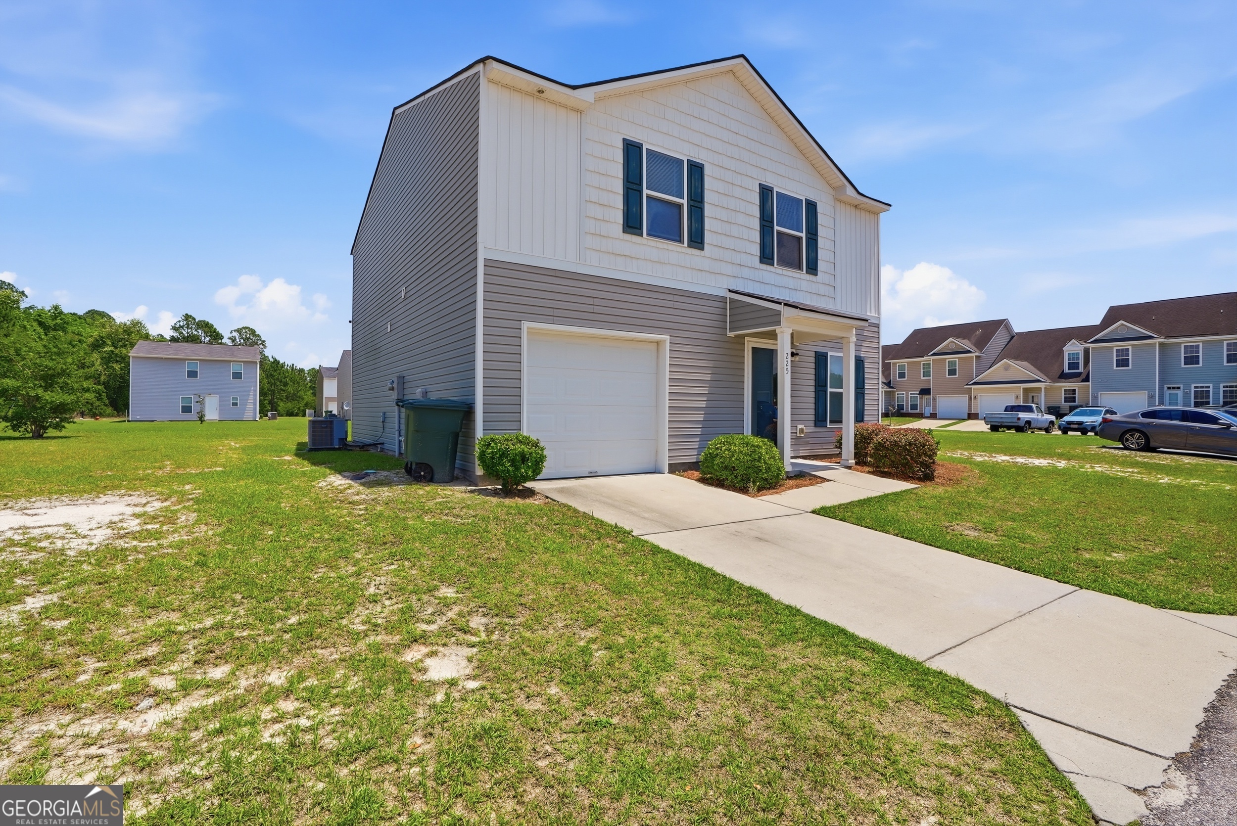 225 Rendell Lane Hinesville, GA 31313 - Photo 2 of 33 a front view of a house with a yard and garage