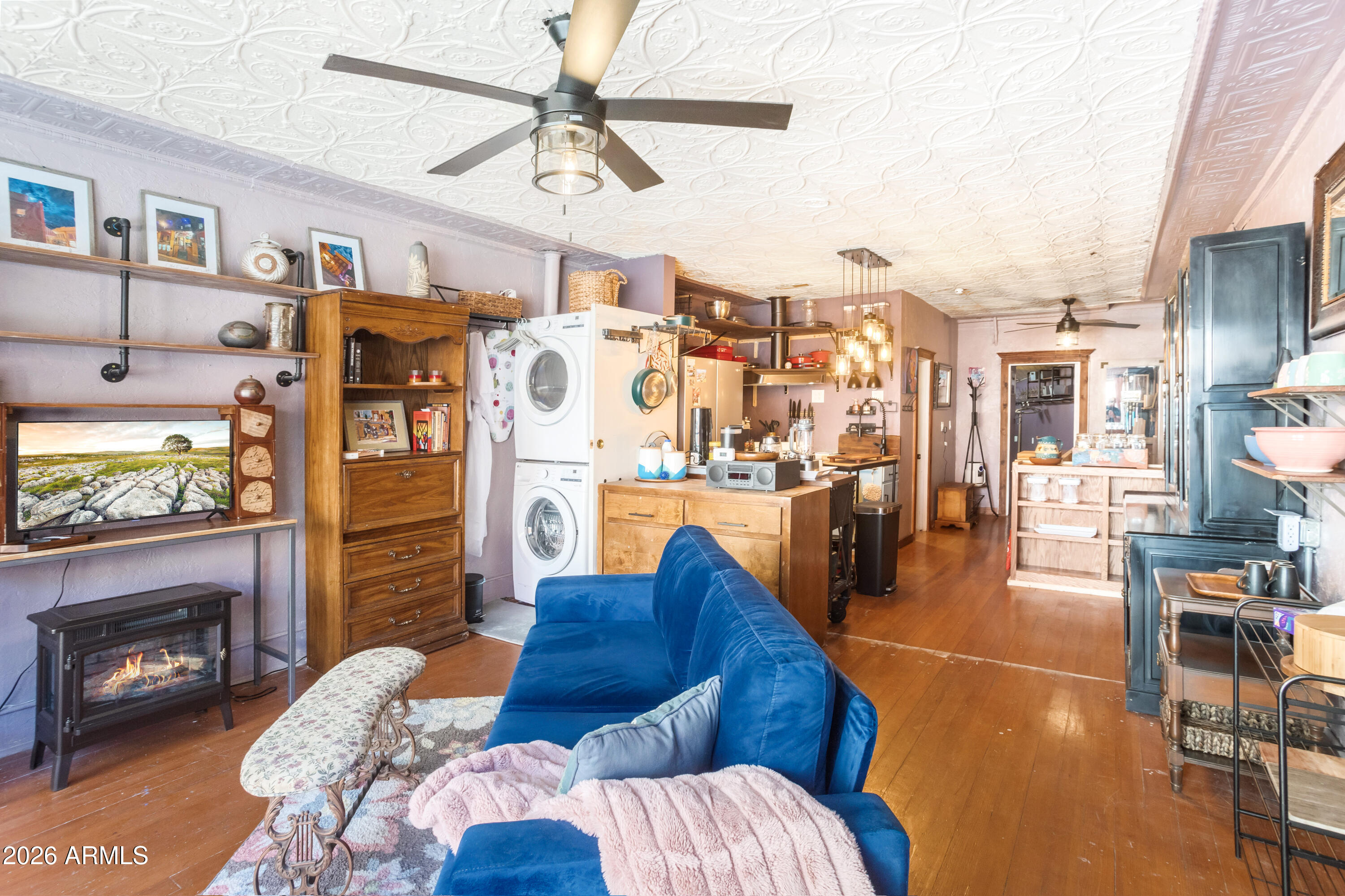 40 Main Street Bisbee, AZ 85603 - Photo 28 of 37 a living room with furniture a flat screen tv and a fireplace