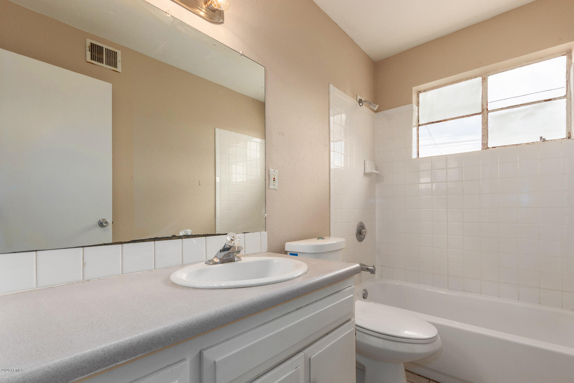 3320 West Cactus Road Phoenix, AZ 85029 - Photo 22 of 29 a bathroom with a granite countertop sink toilet and a mirror