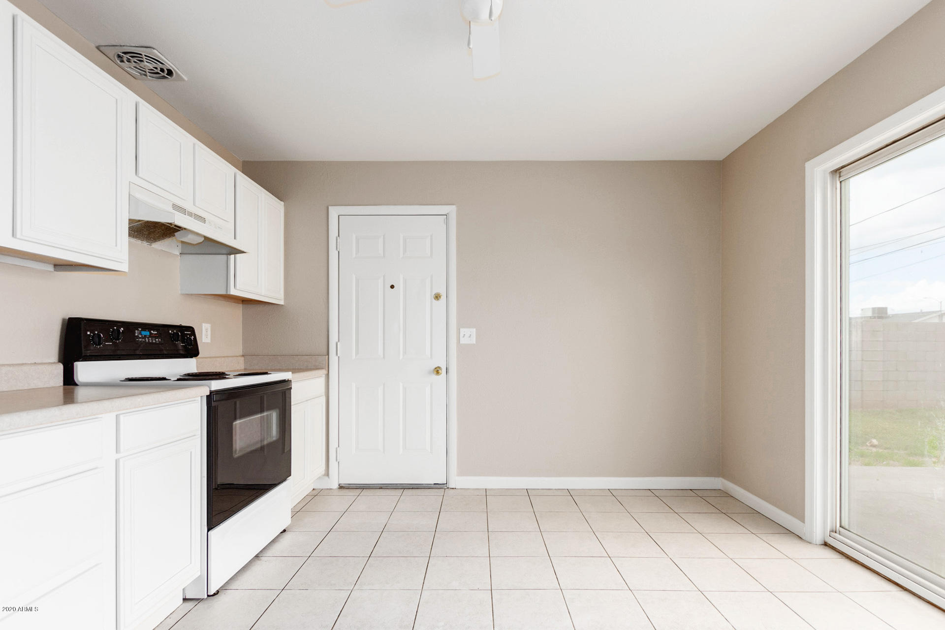3320 West Cactus Road Phoenix, AZ 85029 - Photo 8 of 29 a kitchen with a stove a sink and a refrigerator