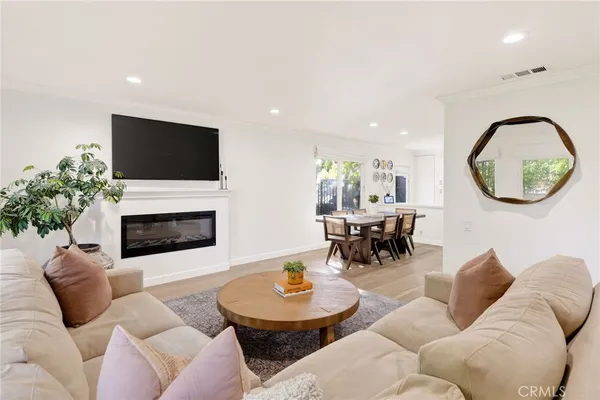 a living room with furniture window and wooden floor