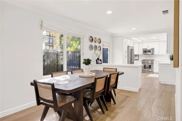a kitchen with stainless steel appliances a refrigerator and a stove top oven