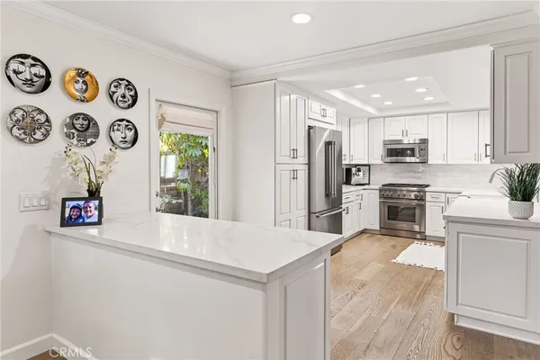 a kitchen with stainless steel appliances kitchen island granite countertop a sink a stove a microwave a counter space and cabinets