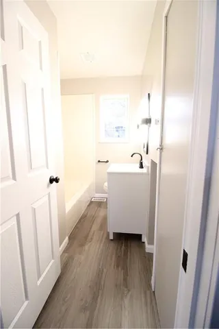 a view of a room with wooden floor