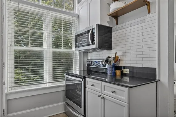 a kitchen with stainless steel appliances a refrigerator sink and cabinets