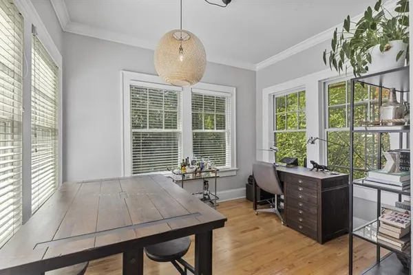 a view of a dining room with furniture large windows and wooden floor