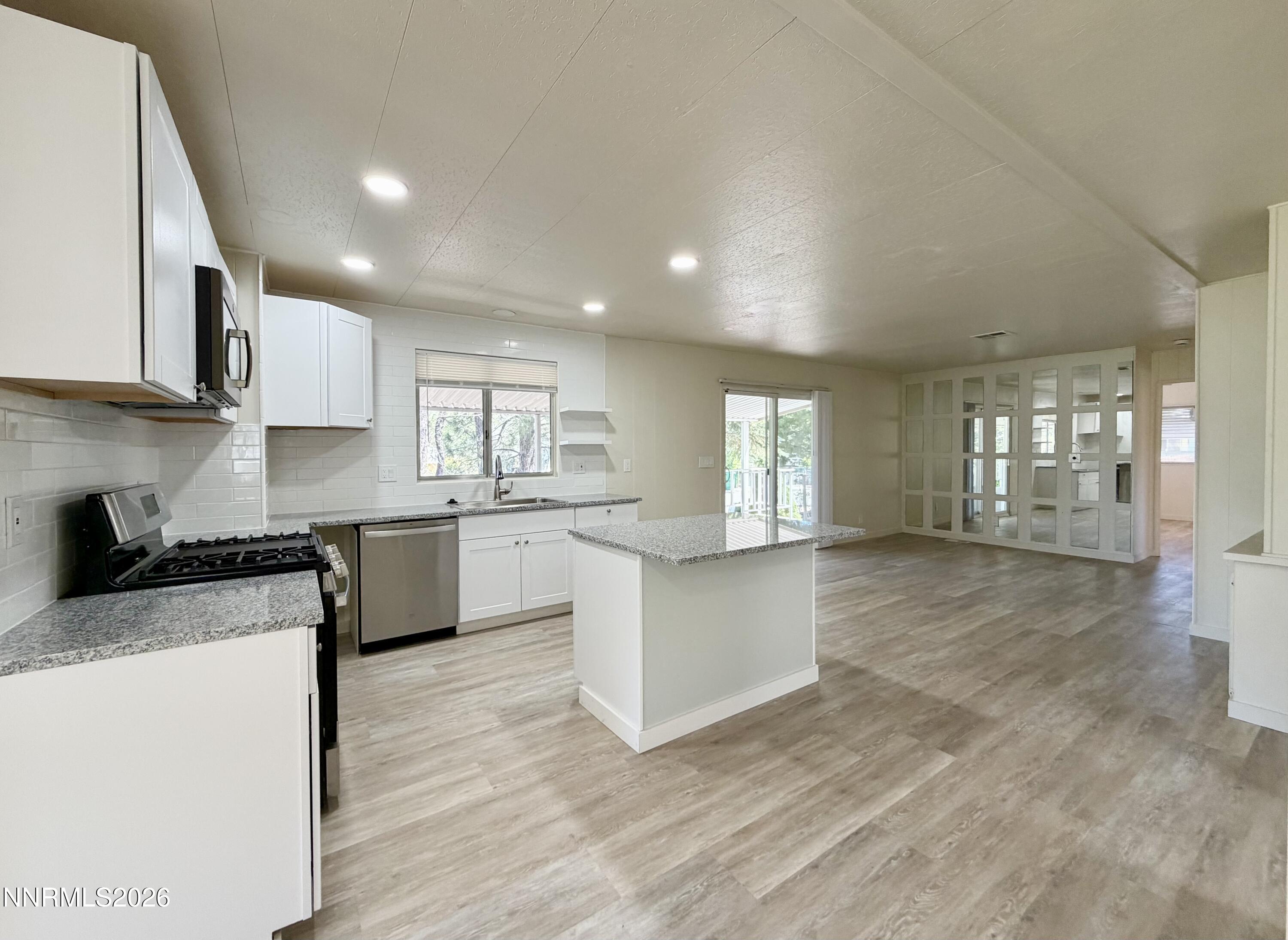 330 Taurus Circle Reno, NV 89521 - Photo 11 of 27 a kitchen with stainless steel appliances granite countertop a stove a sink and a microwave