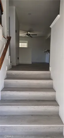 an empty room with wooden floor and fireplace