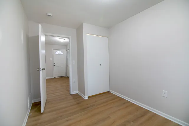 a view of a room with wooden floor