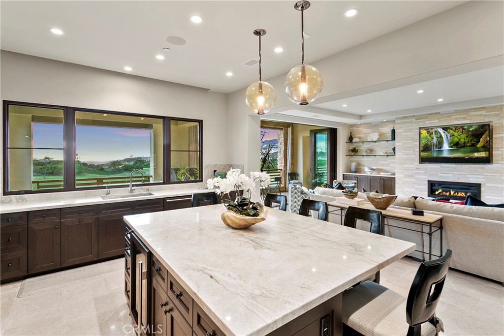 6 Monarch Beach Resort North Dana Point, CA 92629 - Photo 13 of 47 a kitchen with a stove a sink a dining table and chairs
