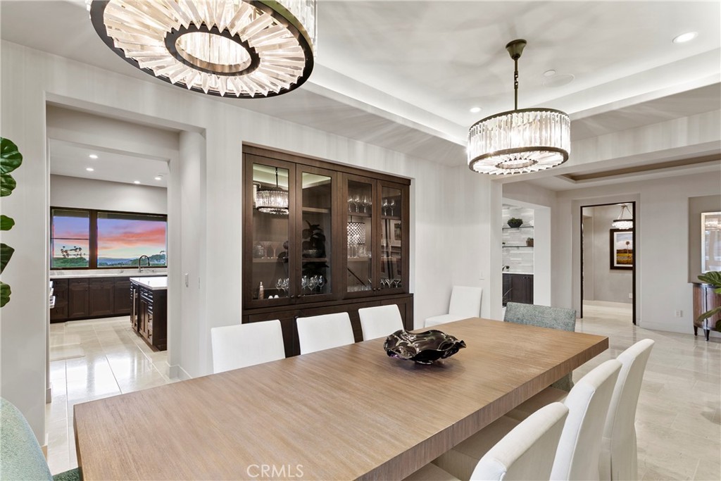 6 Monarch Beach Resort North Dana Point, CA 92629 - Photo 18 of 47 a dining room with wooden floor a chandelier a wooden table and chairs