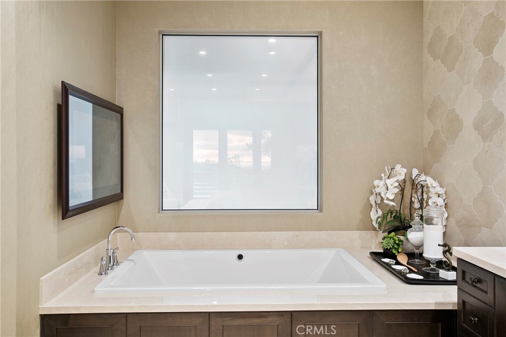 6 Monarch Beach Resort North Dana Point, CA 92629 - Photo 24 of 47 a bathroom with a tub sink and mirror