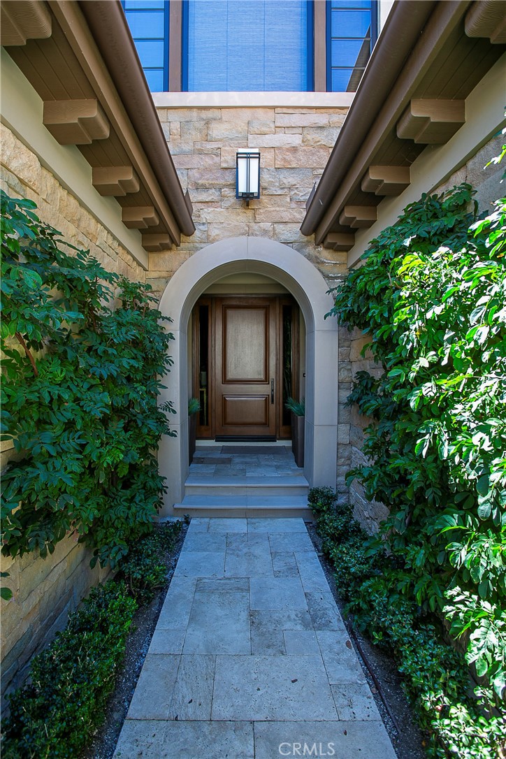 6 Monarch Beach Resort North Dana Point, CA 92629 - Photo 3 of 47 a front view of a house with plants and garden
