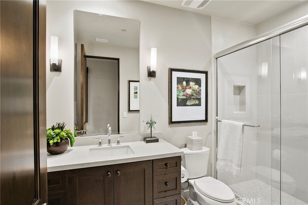 6 Monarch Beach Resort North Dana Point, CA 92629 - Photo 32 of 47 a bathroom with a toilet a sink and mirror