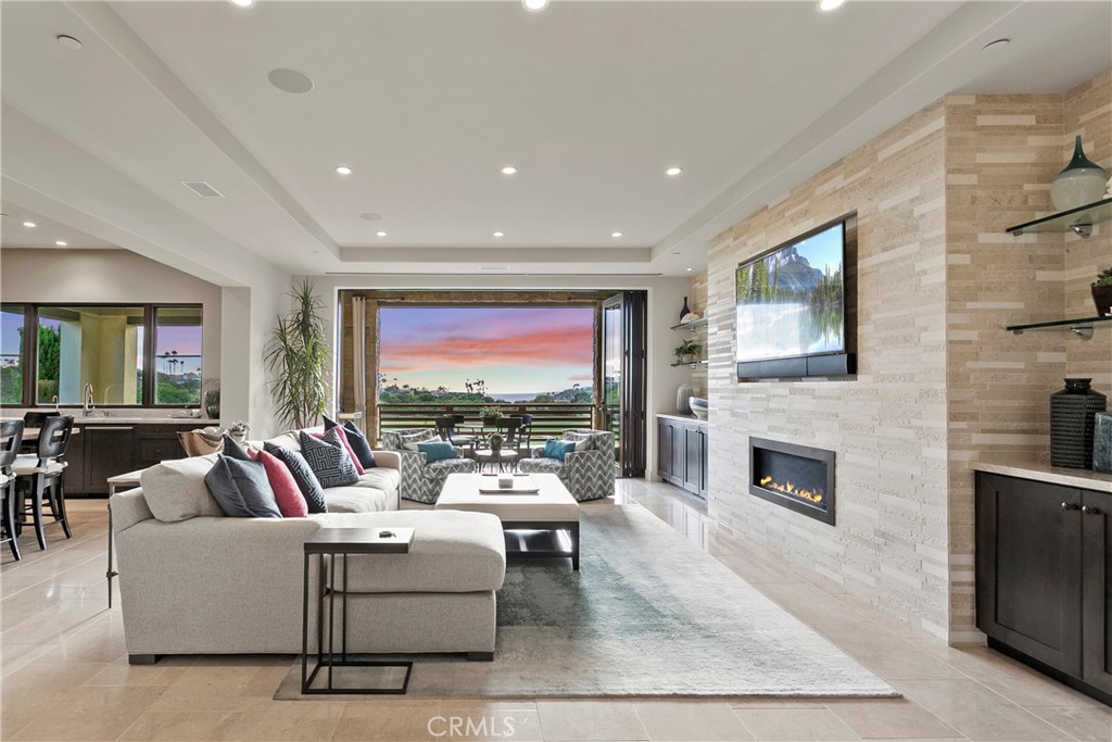 6 Monarch Beach Resort North Dana Point, CA 92629 - Photo 8 of 47 a living room with fireplace furniture and a flat screen tv