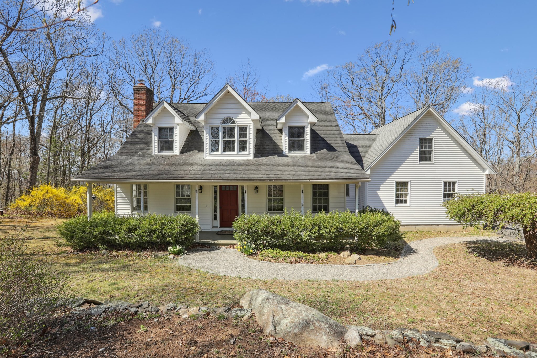 a front view of house with yard and trees around