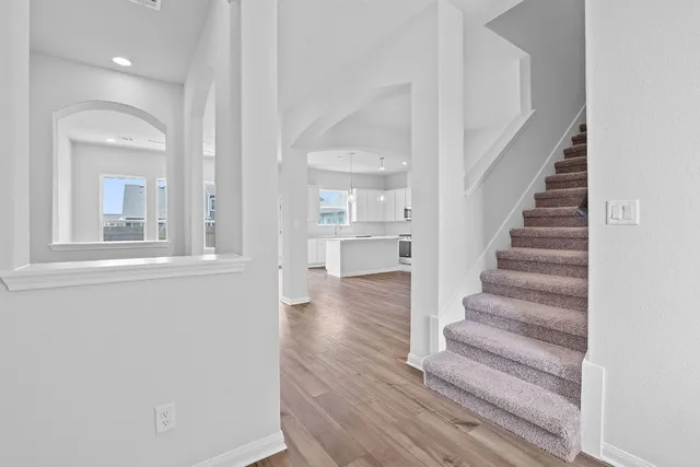 a view of an entryway with wooden floor and windows
