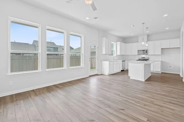 a view of kitchen with wooden floor and windows