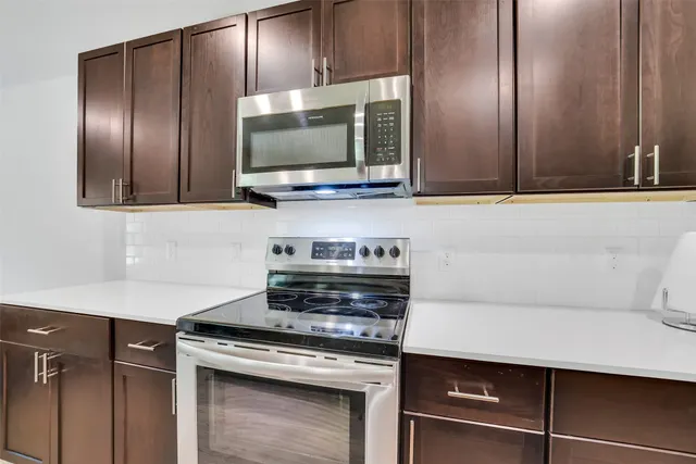 a kitchen with a stove and a microwave