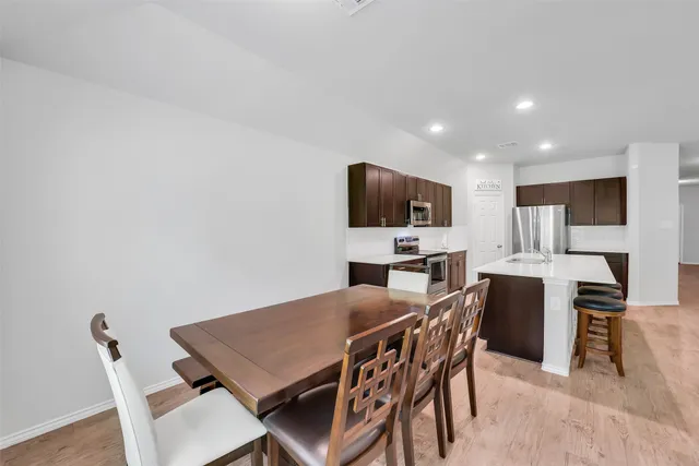 a view of a dining room with furniture and wooden floor