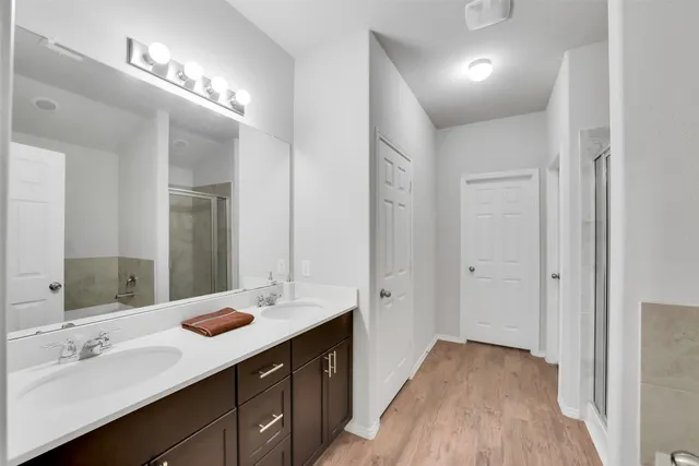 a en suite bathroom with a double vanity sink and a mirror