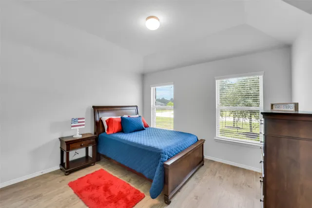 a bedroom with a bed and window