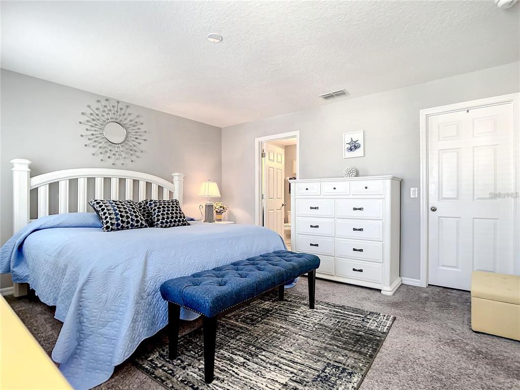 1300 Cavender Creek Road Minneola, FL 34715 - Photo 12 of 28 a bedroom with a bed and a cabinets