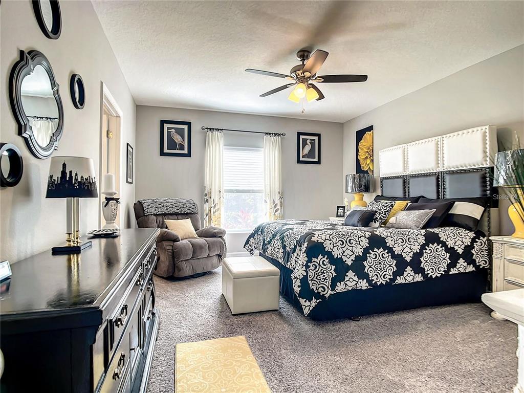 1300 Cavender Creek Road Minneola, FL 34715 - Photo 16 of 28 a bedroom with bed and window
