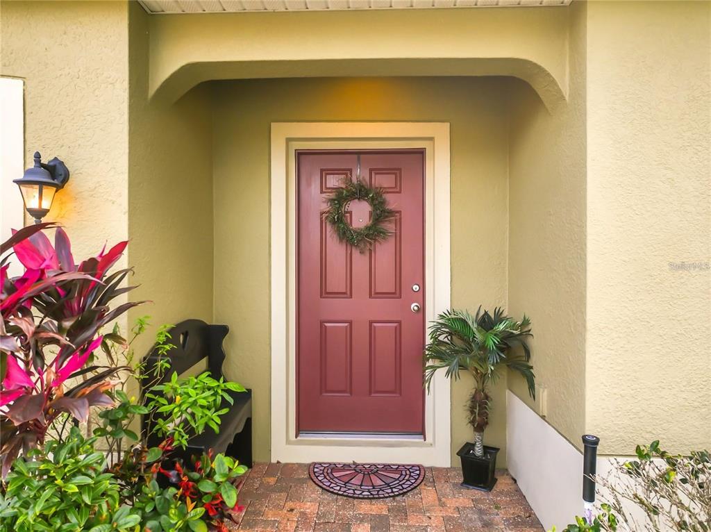 1300 Cavender Creek Road Minneola, FL 34715 - Photo 2 of 28 a front view of a house with a potted plant