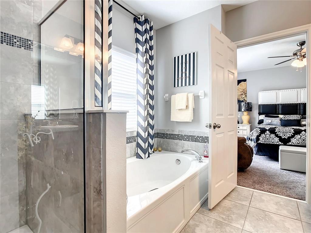 1300 Cavender Creek Road Minneola, FL 34715 - Photo 4 of 28 a bathroom with a bathtub sink and a shower