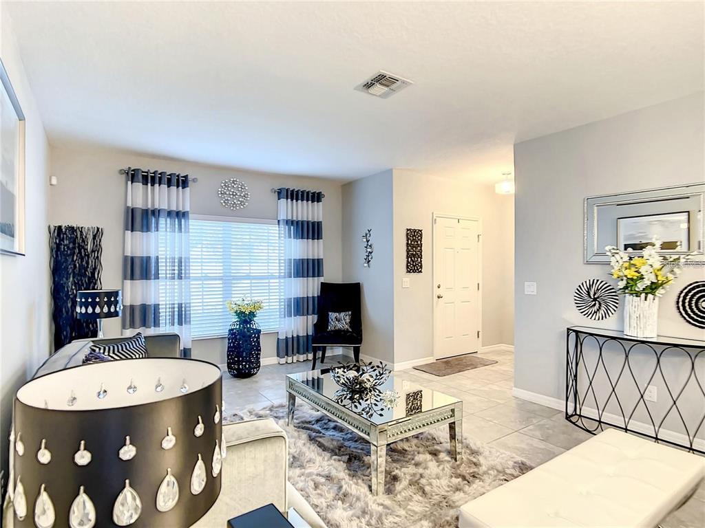 1300 Cavender Creek Road Minneola, FL 34715 - Photo 6 of 28 a living room with furniture and wooden floor