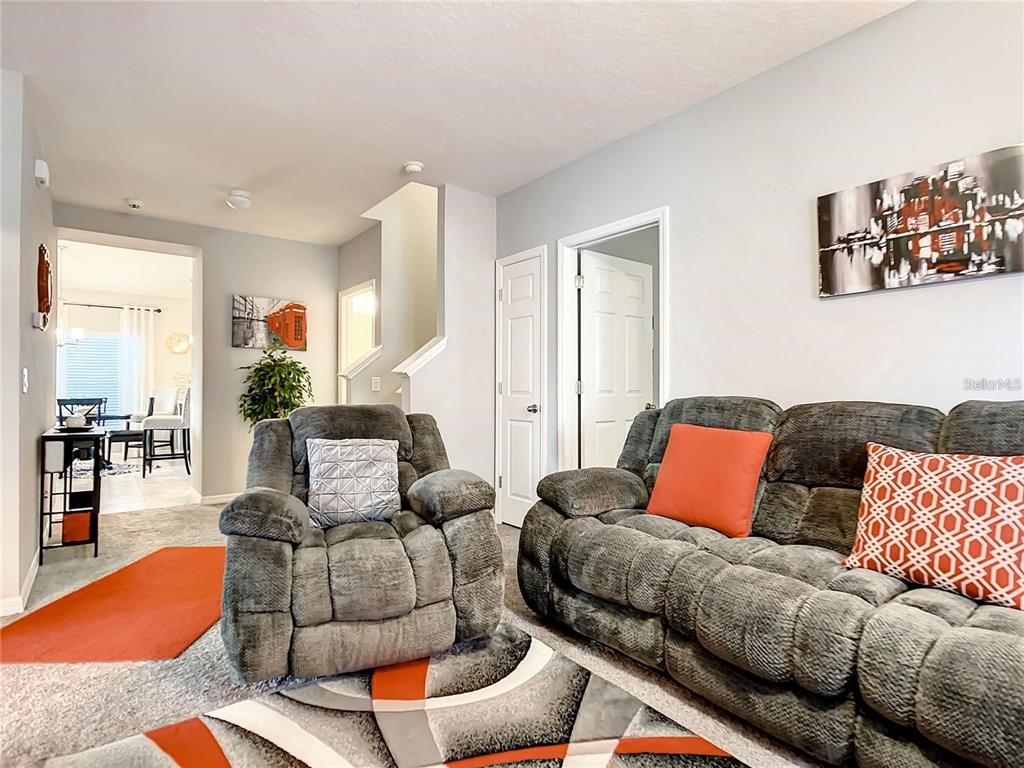 1300 Cavender Creek Road Minneola, FL 34715 - Photo 9 of 28 a living room with furniture and a couch