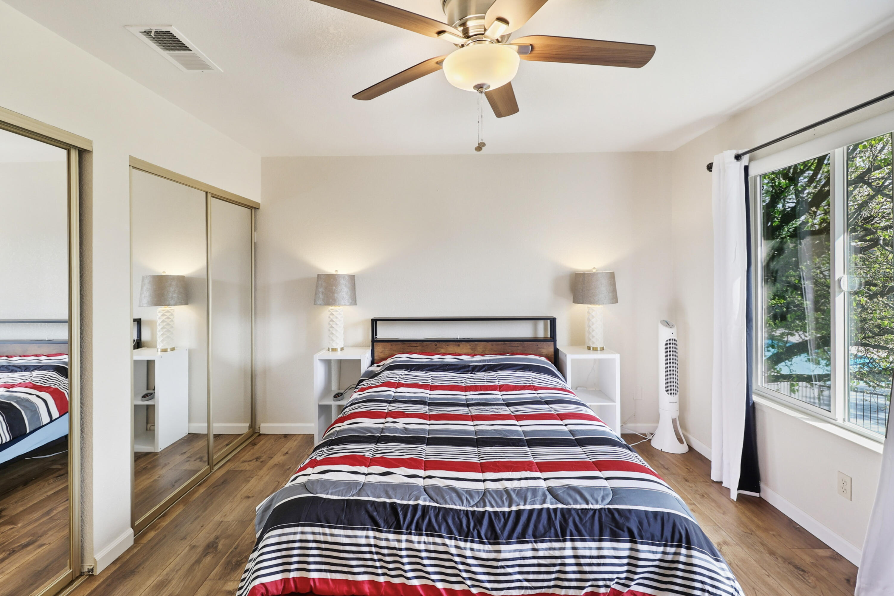 200 Ridgetop Drive, Unit 31 Redding, CA 96003 - Photo 16 of 34 a room with a bed and a chandelier