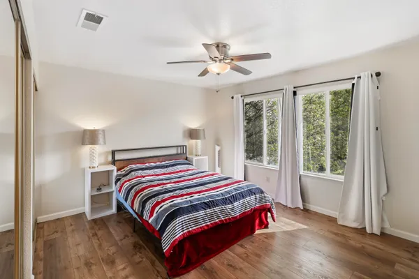 a bathroom with a double vanity sink and mirror with shower
