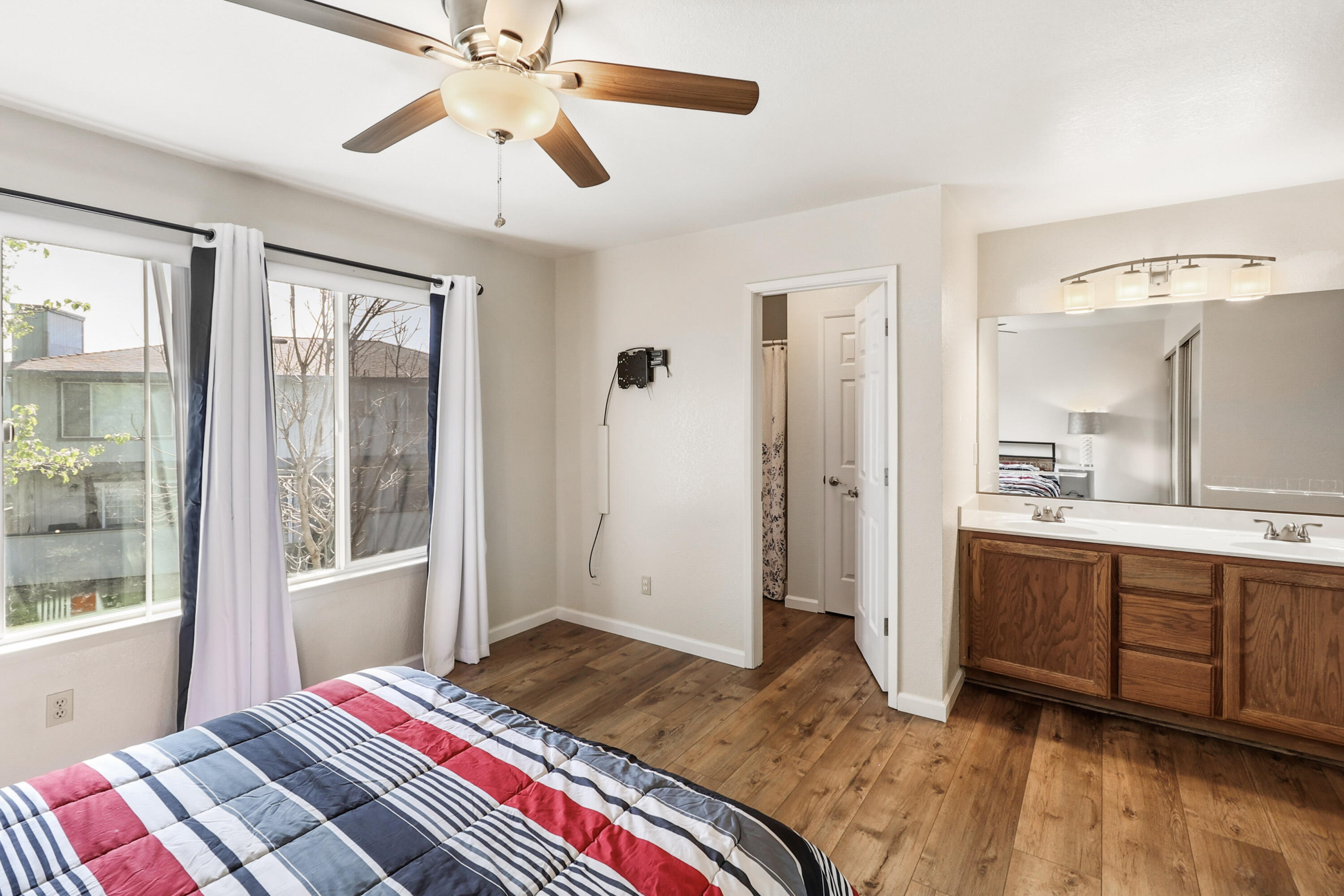 200 Ridgetop Drive, Unit 31 Redding, CA 96003 - Photo 19 of 34 a bedroom with a bed and a chandelier fan