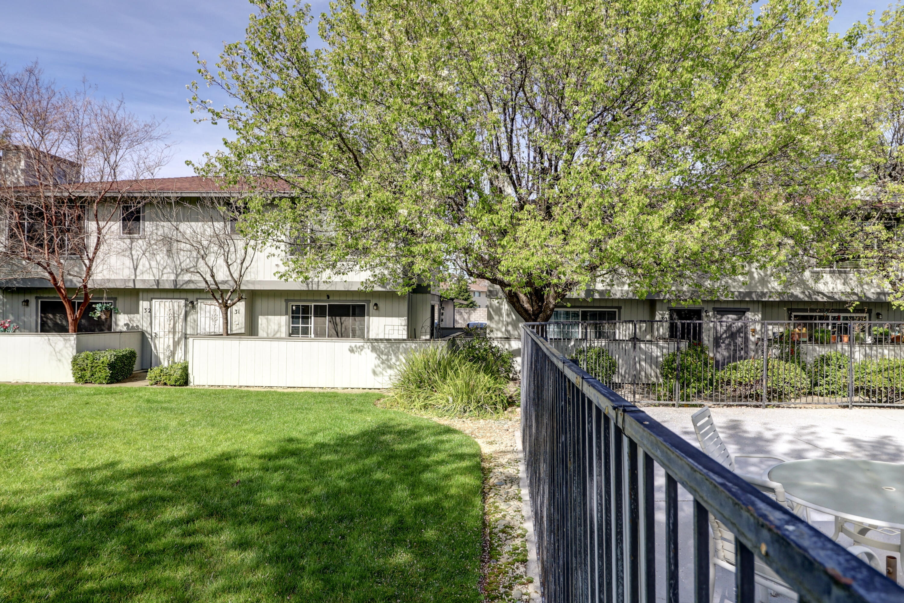 200 Ridgetop Drive, Unit 31 Redding, CA 96003 - Photo 27 of 34 a view of a house in front of a yard with plants and a large tree